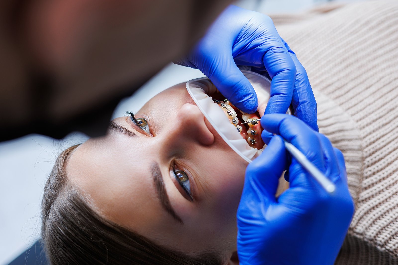 Orthodontist Adjusting Metal Braces During Treatment